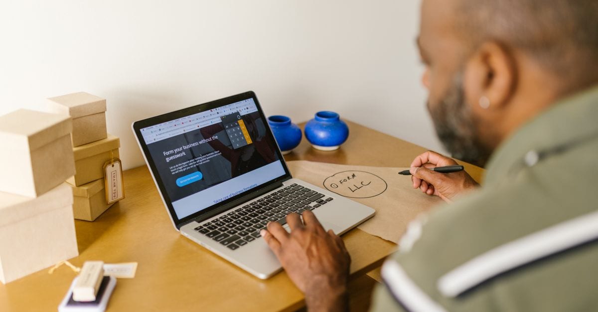 Small business owner reviewing invoices on a laptop